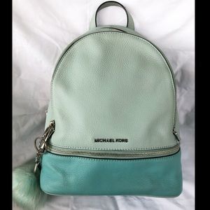Two toned Mint Michael Kors backpack with a plush key chain